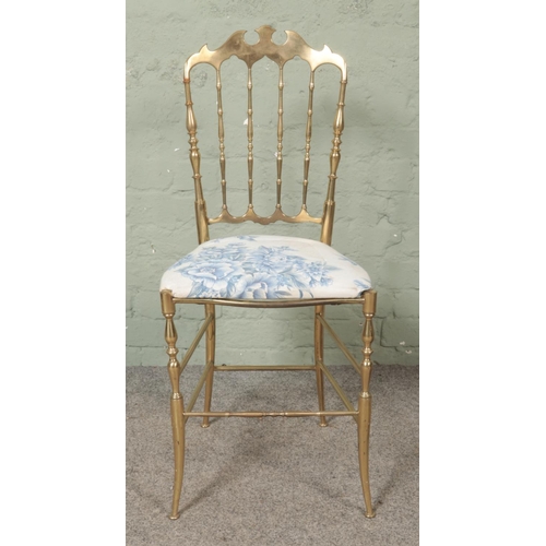 482 - An Italian brass Chiavari chair, with shaped and spindle back rest on turned supports.