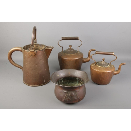 90 - A copper jug together with two graduated tea pot and an Art Nouveau Soutter & Sons copper jardinière