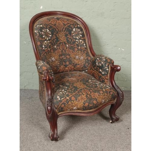 485 - A Victorian mahogany scrolling carved armchair with William Morris Honeysuckle upholstery