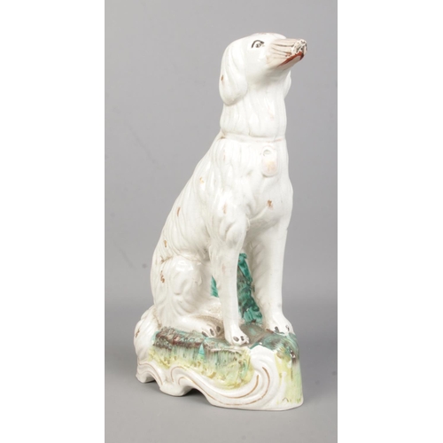 10 - A 19th century Staffordshire figure of a dog, possibly an Irish Setter. Height 28.5cm.