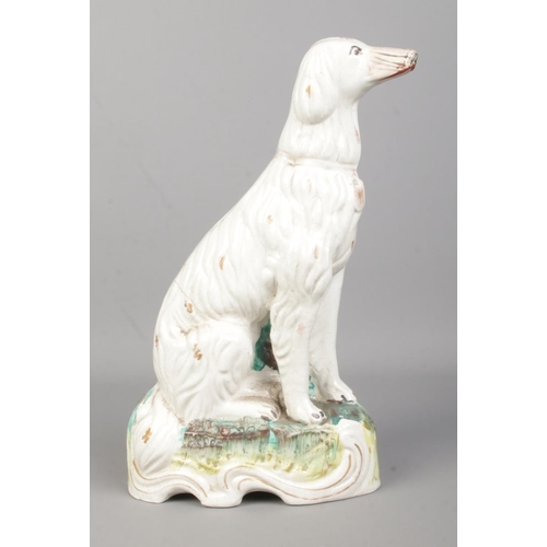 10 - A 19th century Staffordshire figure of a dog, possibly an Irish Setter. Height 28.5cm.