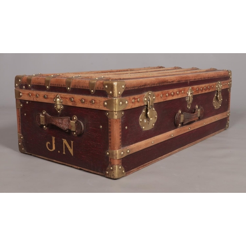 103 - A vintage French wood and brass bound steamer trunk. The brass locks marked Surete.