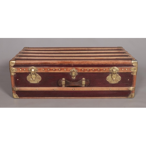 103 - A vintage French wood and brass bound steamer trunk. The brass locks marked Surete.