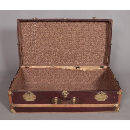 103 - A vintage French wood and brass bound steamer trunk. The brass locks marked Surete.