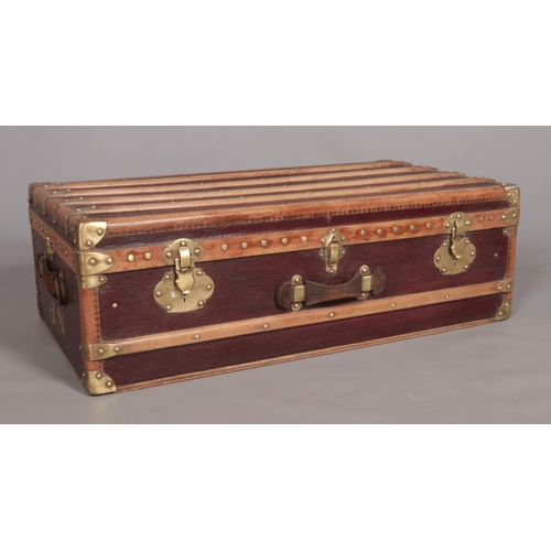 103 - A vintage French wood and brass bound steamer trunk. The brass locks marked Surete.