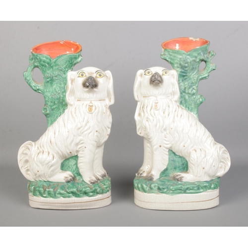 11 - A large pair of Staffordshire dog spill vases. Height 33cm.