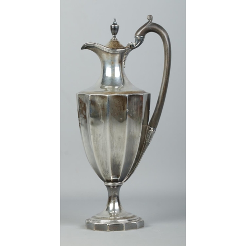 117 - A George III silver ewer/hot water pot with wooden handle. Weighted base. Assayed London 1787 by Hen... 