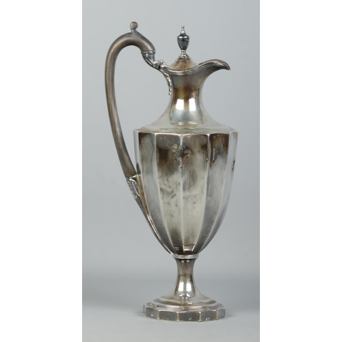 117 - A George III silver ewer/hot water pot with wooden handle. Weighted base. Assayed London 1787 by Hen... 