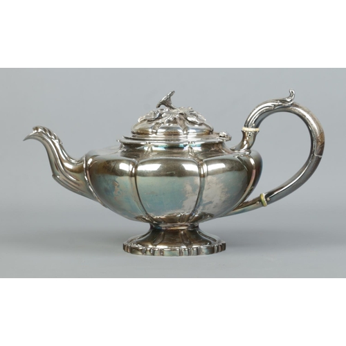 118 - A William IV silver teapot with floral finial. Assayed London 1836 by Edward Barton. 702g. Ivory Sub... 