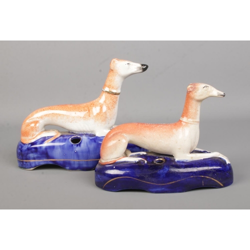 12 - Two 19th century Staffordshire greyhound inkwells. Length of biggest 20cm.