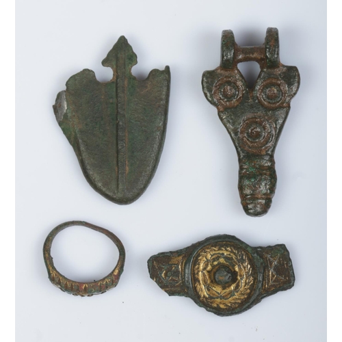 130 - Four metal detector finds; scabbard chape, brooch, bronze ring and one other bronze item.