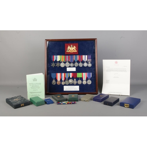 138 - A cased display of eighteen medals awarded to Arthur Baker, including World War Two and Royal Househ... 