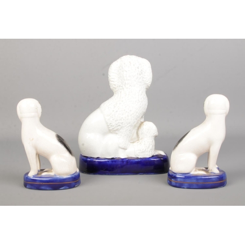 14 - A 19th century Staffordshire poodle with puppies along with a smaller pair of dogs. Tallest 19cm.