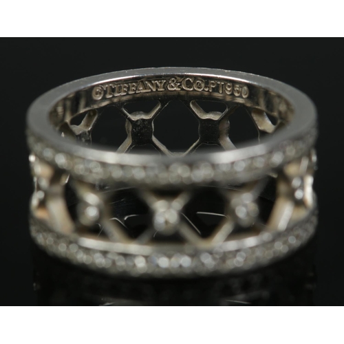 142 - A Tiffany & Co Voile platinum and diamond open band ring. Size K. Hallmarks for London 2006. 6.55g.