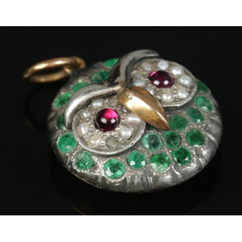 148 - A high carat yellow gold and white metal pendant formed as an owl. With garnet, seed pearl and emera... 