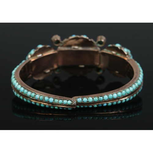 163 - A 19th century yellow metal bangle set with turquoise stones.