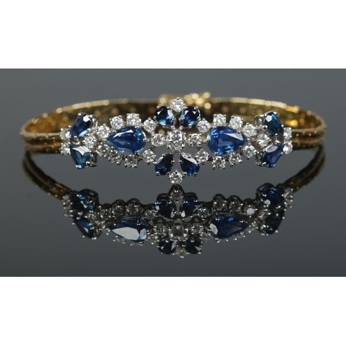 166 - An 18ct gold sapphire and diamond bracelet. Having London import marks, 1984. Length 18cm. 14.83g.