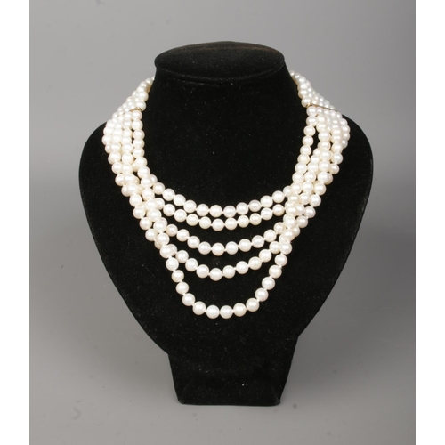 168 - A five row pearl necklace with 18ct gold clasp. The clasp stamped 750 and maker's mark HKJ.