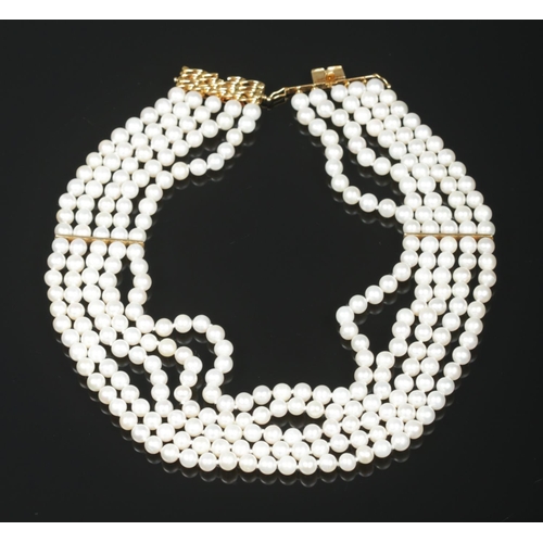 168 - A five row pearl necklace with 18ct gold clasp. The clasp stamped 750 and maker's mark HKJ.