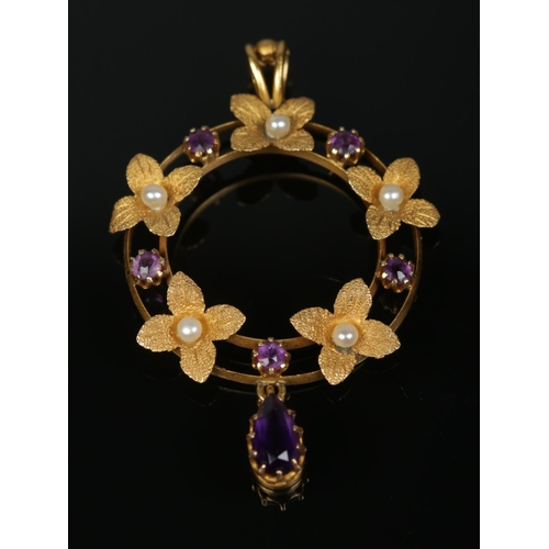 172 - An Edwardian 15ct gold, amethyst and seed pearl pendant with frosted leaf decoration. 2.1g.