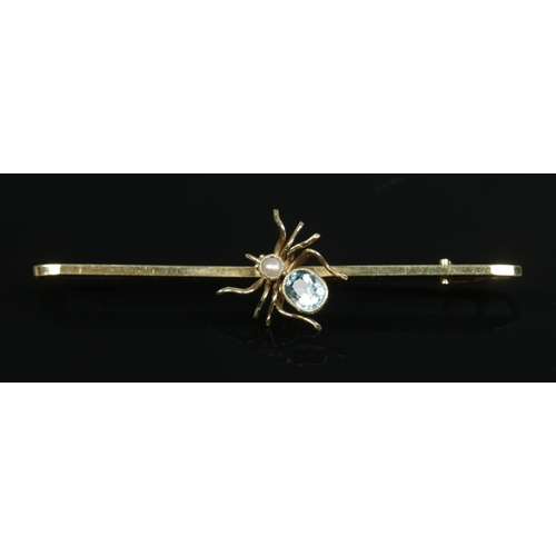 174 - A 15ct gold aquamarine and pearl spider bar brooch. Length 6cm. 3.75g.