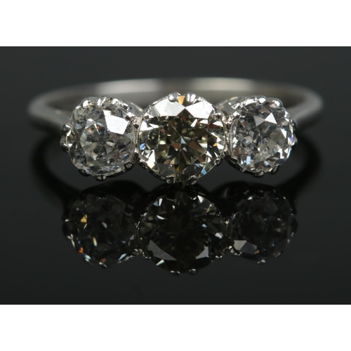 196 - A platinum and old cut diamond three stone ring. Total diamond approximately 1.6ct. Size N. 3.36g.