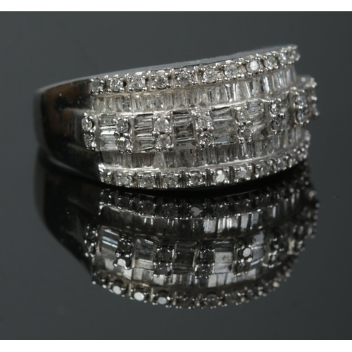 198 - A ladies 10ct white gold and diamond ring. The diamonds baguette and brilliant cut in a channel sett... 