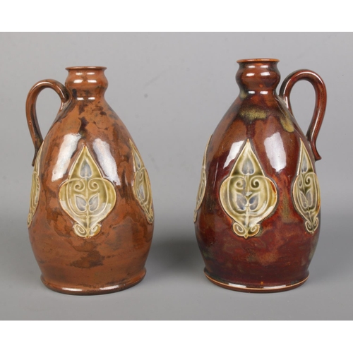 20 - A near pair of early 20th century Royal Doulton stoneware flasks. Tallest 20cm.