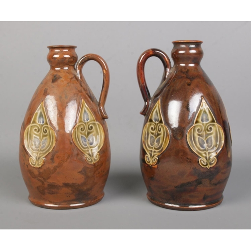 20 - A near pair of early 20th century Royal Doulton stoneware flasks. Tallest 20cm.