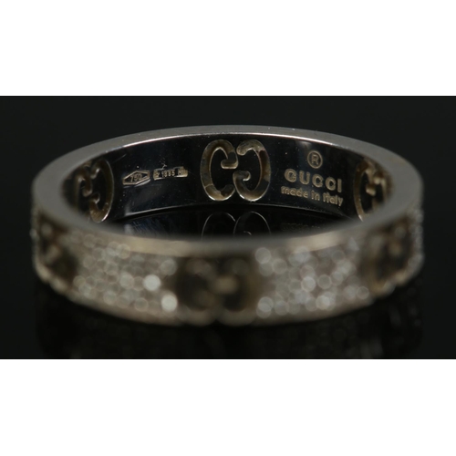 201 - A Gucci 18ct white gold and diamond ring with pierced initials. Size L. 3.46g.