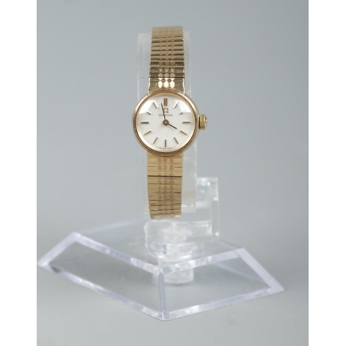 205 - A ladies 9ct gold Omega manual wristwatch on 9ct gold Omega strap. With box and papers. 18.9g.