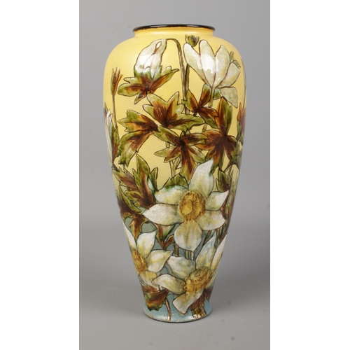 27 - A Linthorpe pottery vase decorated with flowers. Height 27cm.