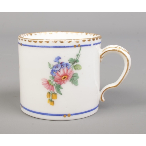 29 - A late 18th century Sevres porcelain coffee cup, handpainted with floral sprays. Height 4.7cm.