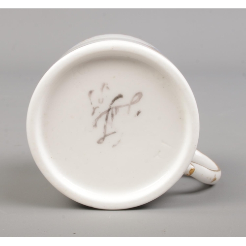 29 - A late 18th century Sevres porcelain coffee cup, handpainted with floral sprays. Height 4.7cm.