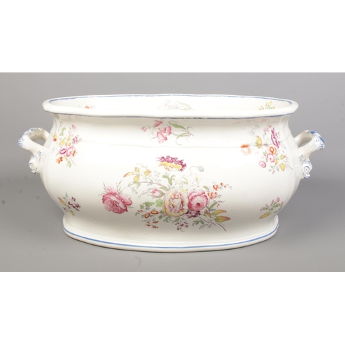 36 - A Victorian ceramic footbath decorated with flowers. Height 21cm, Width 53cm.