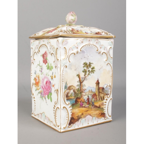 41 - A 19th century porcelain box with cover. With hand painted decoration of landscape scenes and floral... 