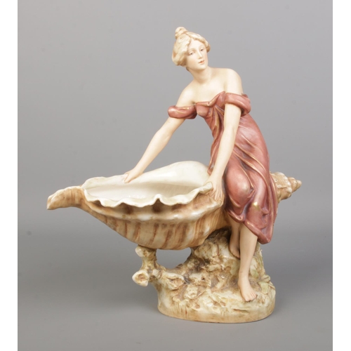 42 - A Royal Dux figure of a maiden seated on a large shell. Height 32cm.