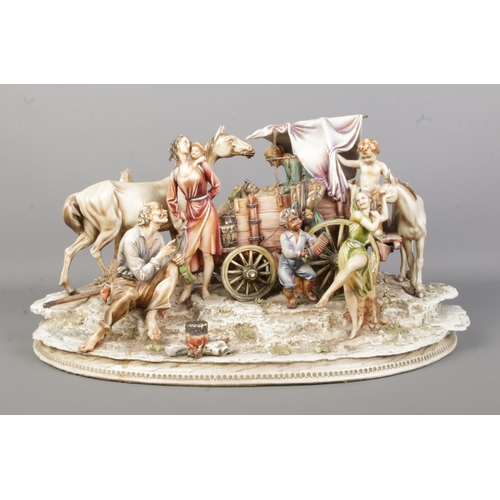 44 - An Antonio Borsato Italian porcelain figure group, depicting figures gathered around a horse and wag... 