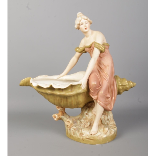 46 - A Royal Dux figure of a maiden seated on a large shell. Height 32cm.