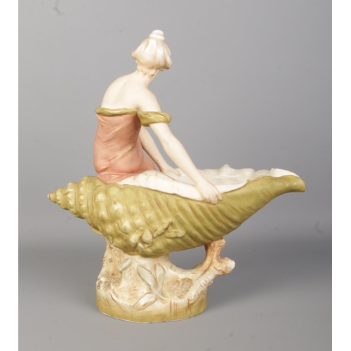 46 - A Royal Dux figure of a maiden seated on a large shell. Height 32cm.