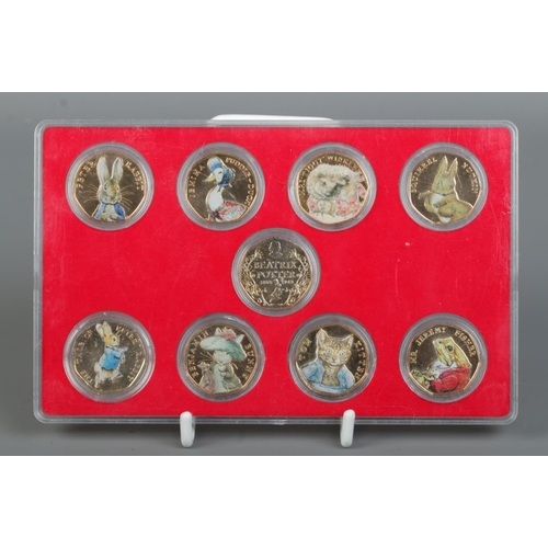 486 - A cased collection of ten Elizabeth II Beatrix Potter 50p coins, dated 2016 and 2017. Gold plated wi... 