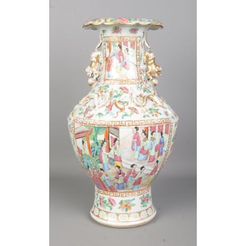 56 - A large late 19th/ early 20th century Chinese Canton Famille Rose vase. With gilt lion dog handles a... 