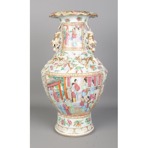 56 - A large late 19th/ early 20th century Chinese Canton Famille Rose vase. With gilt lion dog handles a... 