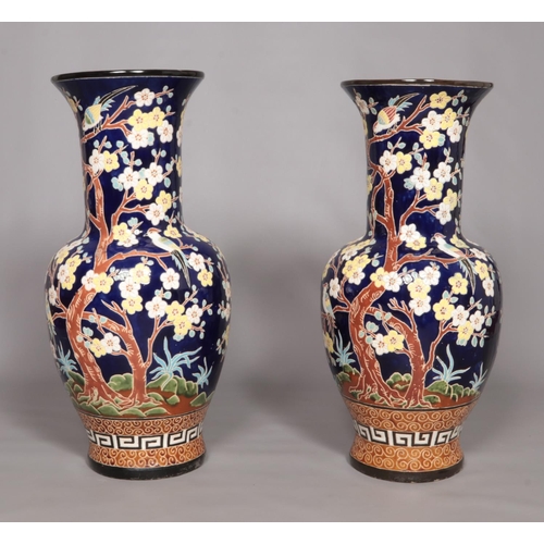 57 - A large pair of Chinese floor vases, blue ground and decorated with birds and prunus blossom. Height... 