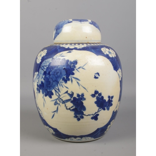 58 - A Chinese blue and white ginger jar decorated with birds and flowers. Having concentric circles to b... 