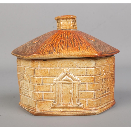 6 - A Brampton pottery salt glazed tobacco jar in the form of a house. Height 10cm.