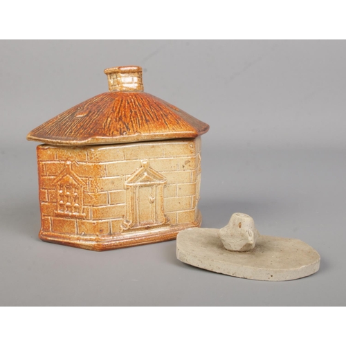 6 - A Brampton pottery salt glazed tobacco jar in the form of a house. Height 10cm.