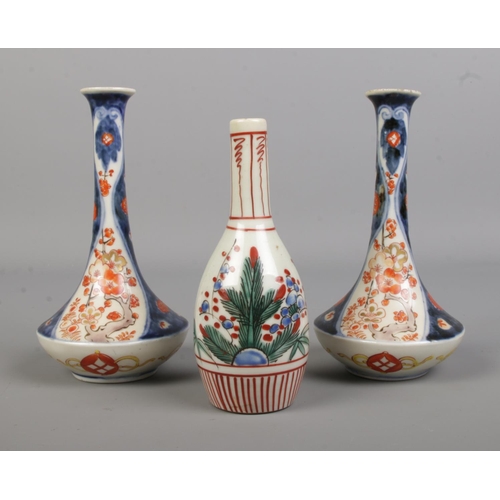 61 - A pair of Japanese imari vases along with a smaller vase. Height of pair 16cm.