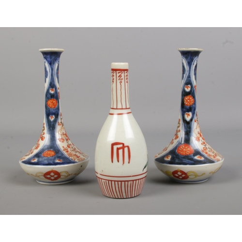 61 - A pair of Japanese imari vases along with a smaller vase. Height of pair 16cm.