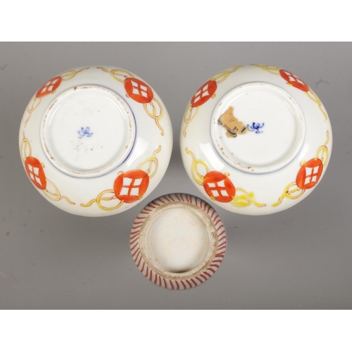 61 - A pair of Japanese imari vases along with a smaller vase. Height of pair 16cm.